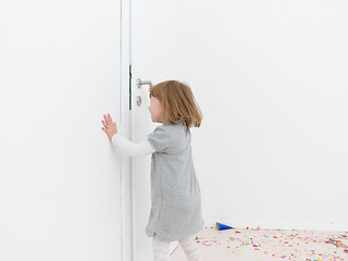 Image showing Little girl standing on confetti