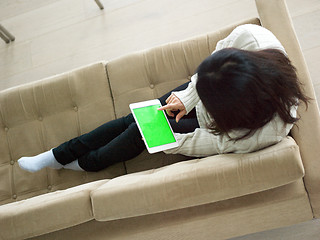 Image showing top view of asian woman using Digital Tablet on sofa