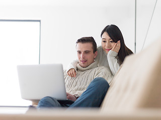 Image showing multiethnic couple using laptop computers