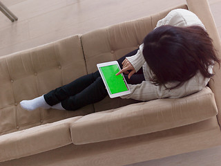 Image showing top view of asian woman using Digital Tablet on sofa