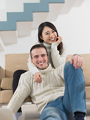 Image showing happy multiethnic couple relaxing at home