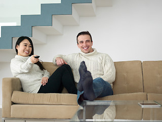 Image showing multiethnic couple on the sofa watching television