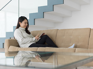 Image showing asian woman using Digital Tablet on sofa