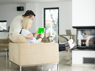 Image showing Couple using digital tablet on cold winter day