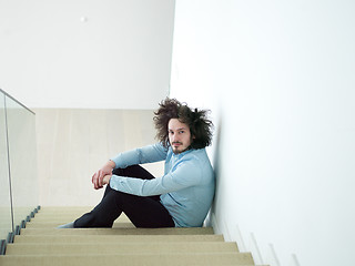 Image showing young man sitting on the stairs