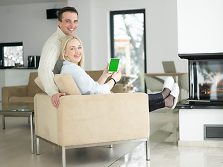 Image showing Couple using digital tablet on cold winter day