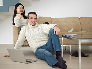 Image showing multiethnic couple on the sofa watching television