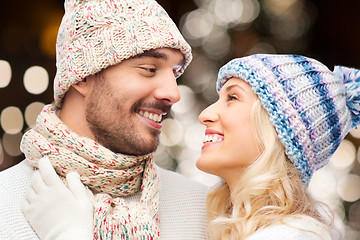 Image showing happy couple hugging over christmas lights