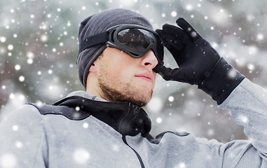 Image showing close up of sports man with ski goggles in winter