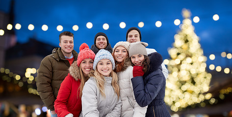 Image showing happy friends taking selfie outdoors at christmas