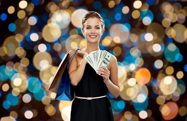 Image showing smiling woman in dress with shopping bags