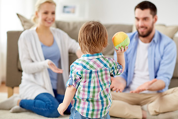 Image showing happy family playing with ball at home