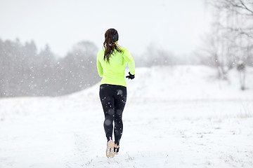 Image showing woman running outdoors in winter