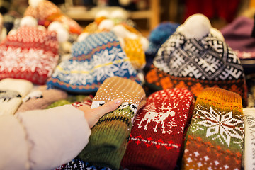 Image showing woman buying woolen mittens at christmas market