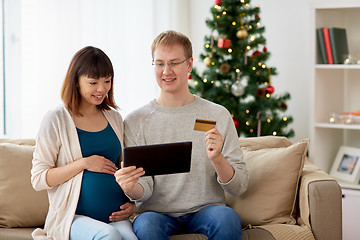 Image showing man and pregnant wife shopping online at christmas