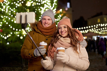 Image showing couple with coffee taking selfie at christmas