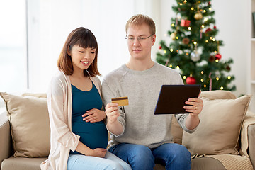 Image showing man and pregnant wife shopping online at christmas