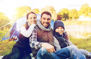 Image showing happy family with tent at camp site