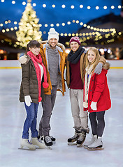 Image showing happy friends at christmas skating rink
