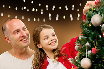 Image showing happy family decorating christmas tree at home