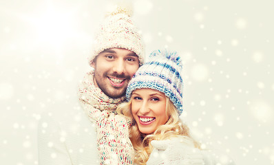 Image showing smiling couple in winter clothes hugging