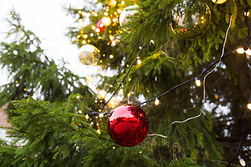 Image showing close up of fir with christmas tree toys outdoors