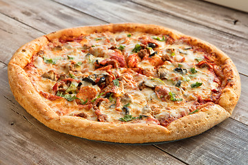 Image showing Pizza On A Wooden Table