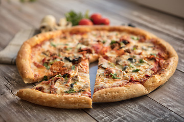 Image showing Pizza On A Wooden Table