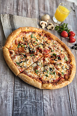 Image showing Pizza On A Wooden Table