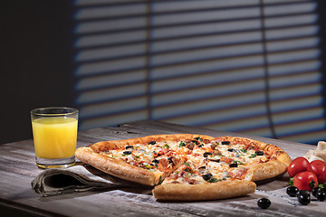 Image showing Pizza On A Wooden Table