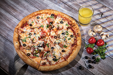 Image showing Pizza On A Wooden Table