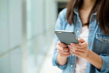 Image showing Woma use of cellphone