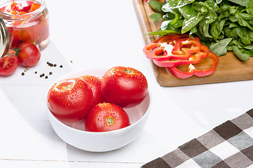 Image showing Canned tomatoes and fresh tomato on white background