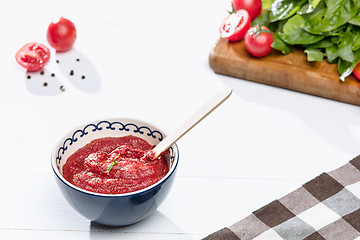 Image showing Bowl of chopped tomatoes on rustic table