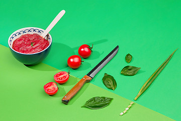Image showing Bowl of chopped tomatoes on green table