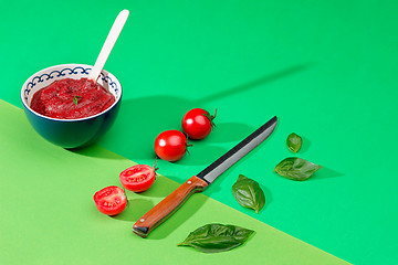 Image showing Bowl of chopped tomatoes on green table