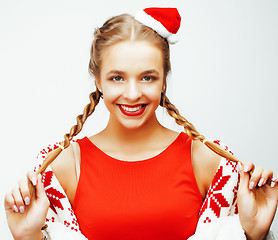 Image showing young pretty happy smiling blond woman on christmas in santas red hat and holiday decorated plaid, lifestyle people concept 