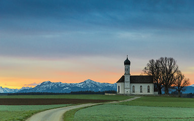 Image showing Sunrise over old chapel in green field