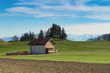 Image showing Alpine mountains spring landscape with wooden shed