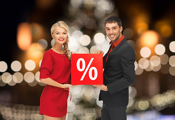 Image showing couple with discount sign over christmas lights