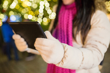 Image showing close up of woman with tablet pc at christmas