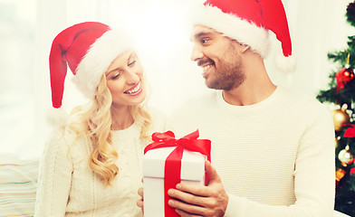 Image showing happy couple at home with christmas gift box