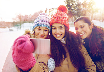 Image showing happy teenage girls taking selfie with smartphone