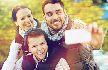 Image showing family with smartphone taking selfie at campsite