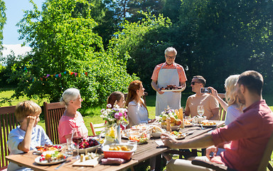 Image showing happy family having dinner or summer garden party
