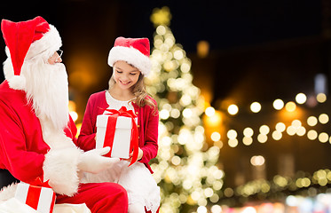 Image showing santa claus and happy girl with christmas gift