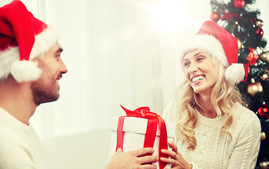 Image showing happy couple at home with christmas gift box