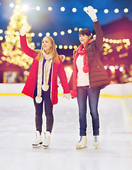 Image showing women waving hands at christmas skating rink