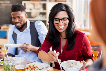 Image showing happy friends eating at restaurant