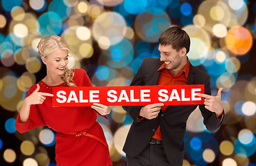 Image showing couple with red sale sign over christmas lights